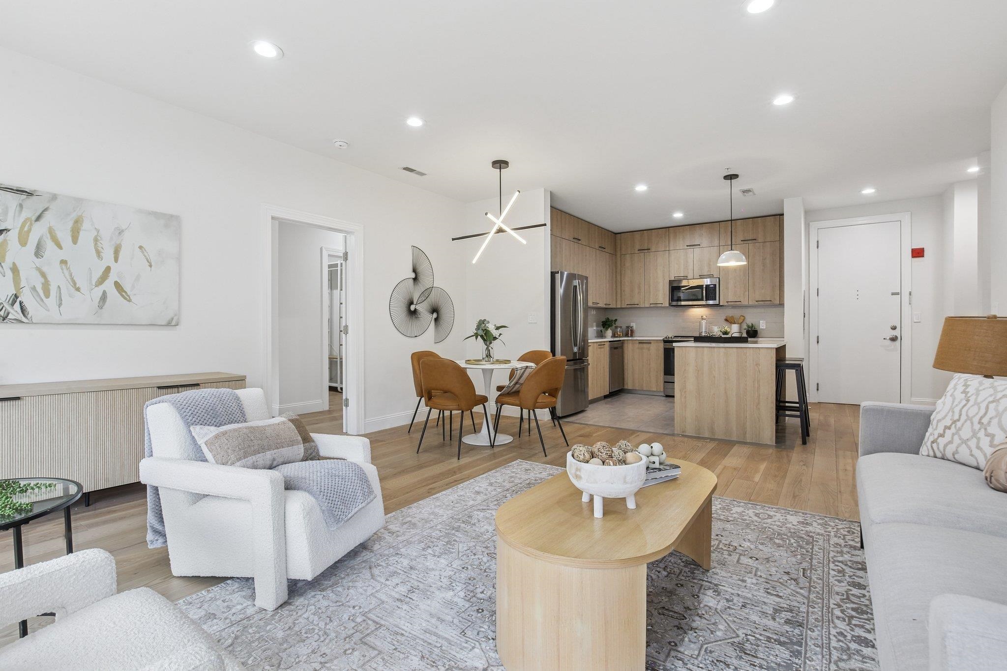 22 Ave At Port Imperial, Unit 208 West New York, NJ 07093 - Photo 18 of 34 a living room with furniture and kitchen view