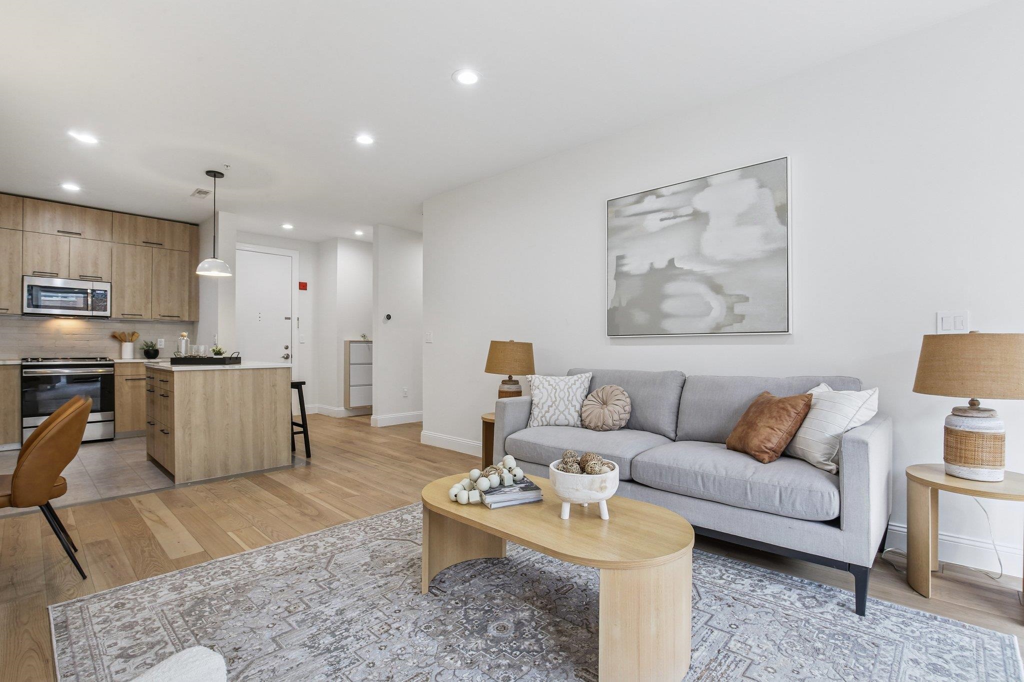 22 Ave At Port Imperial, Unit 208 West New York, NJ 07093 - Photo 19 of 34 a living room with furniture and kitchen view