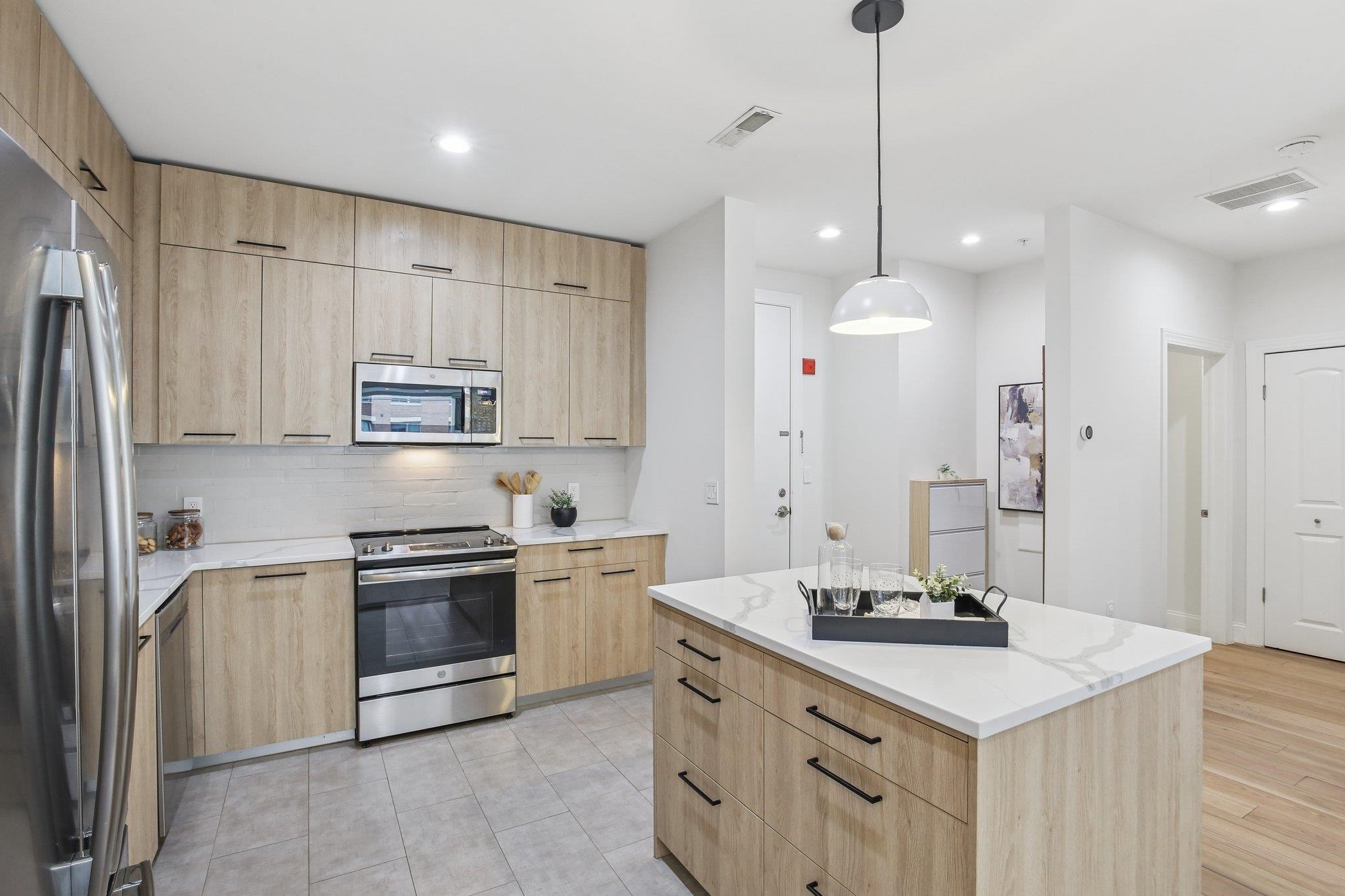 22 Ave At Port Imperial, Unit 208 West New York, NJ 07093 - Photo 2 of 34 a kitchen with stainless steel appliances granite countertop a sink stove and refrigerator