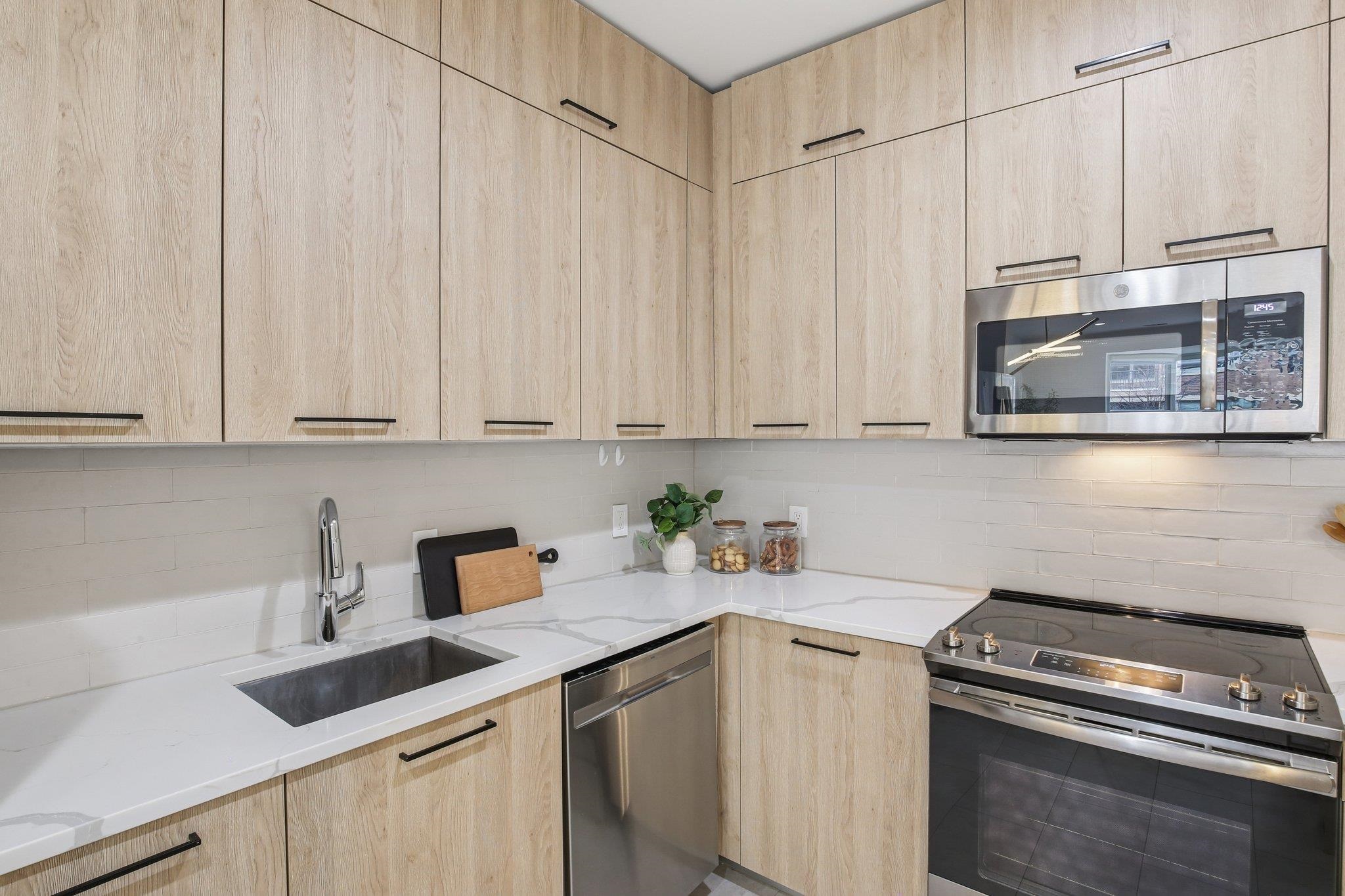 22 Ave At Port Imperial, Unit 208 West New York, NJ 07093 - Photo 3 of 34 a kitchen with a sink cabinets and appliances