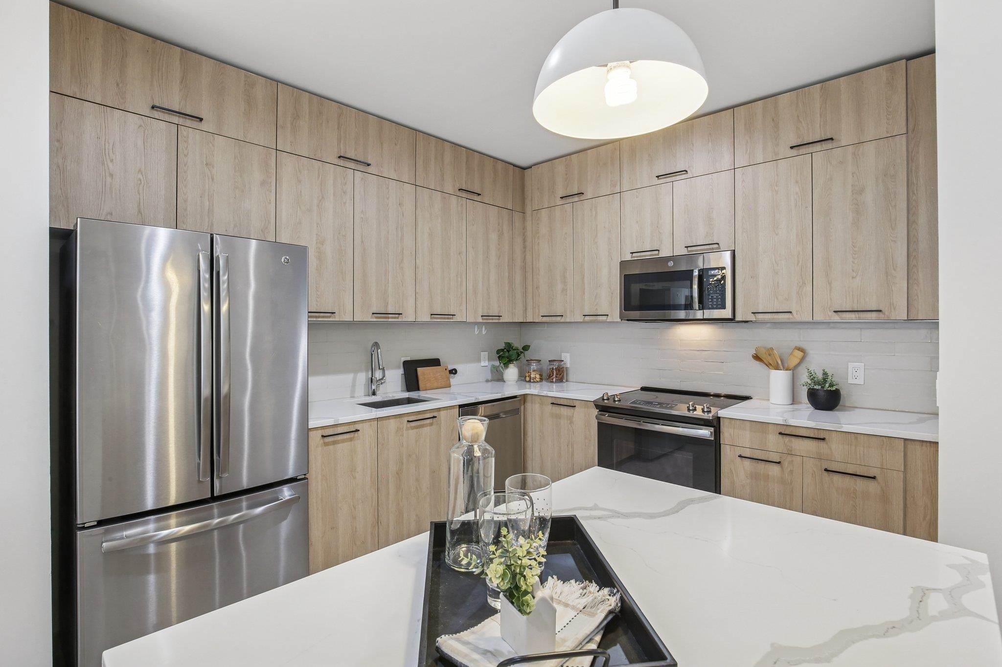 22 Ave At Port Imperial, Unit 208 West New York, NJ 07093 - Photo 4 of 34 a kitchen with stainless steel appliances a refrigerator stove microwave and sink