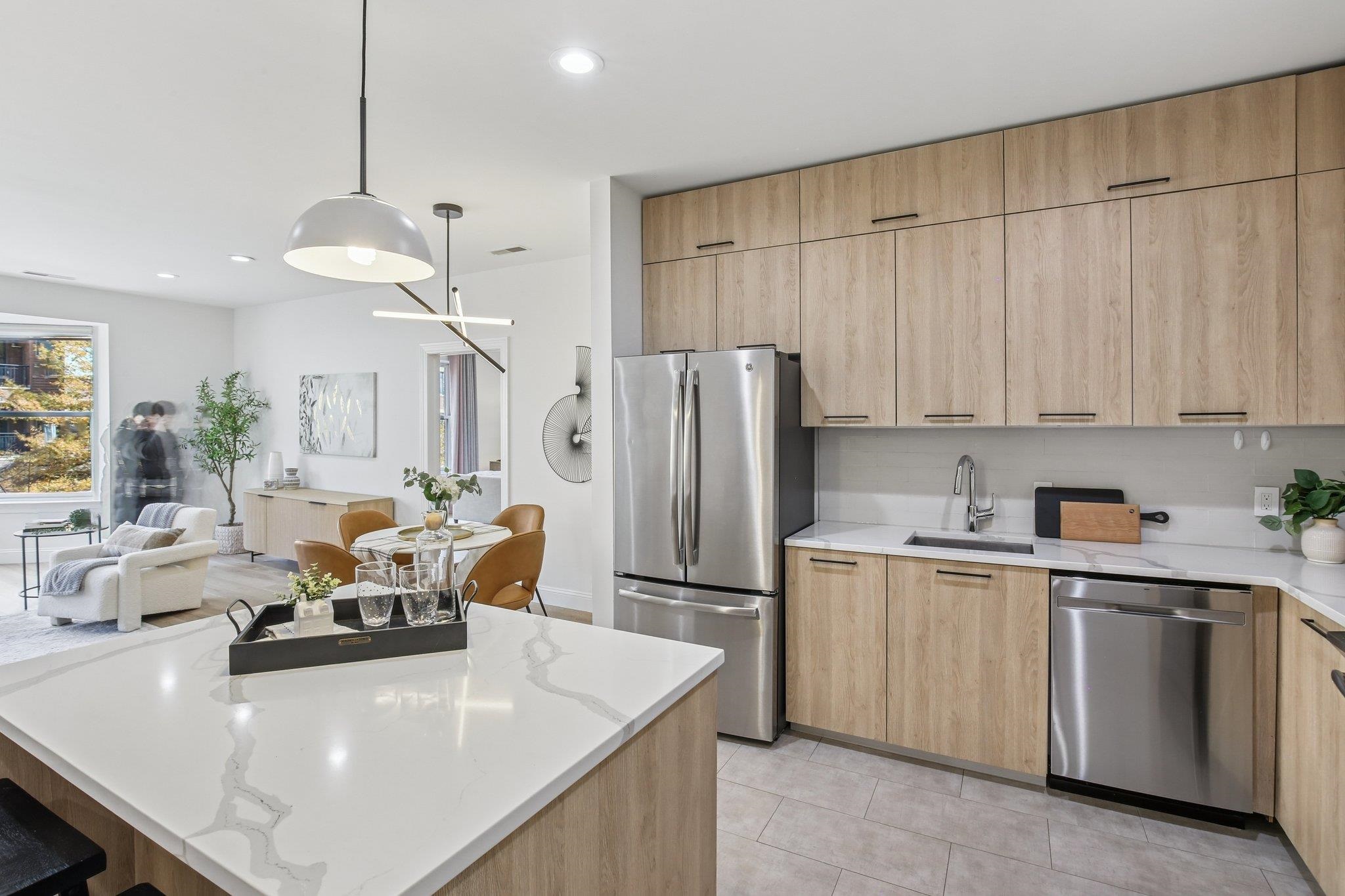 22 Ave At Port Imperial, Unit 208 West New York, NJ 07093 - Photo 5 of 34 a kitchen with white cabinets and stainless steel appliances