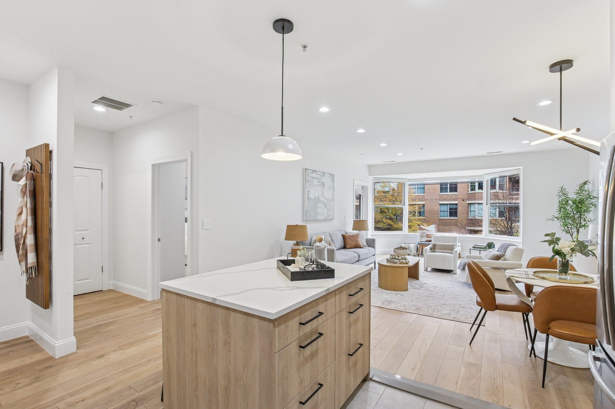 22 Ave At Port Imperial, Unit 208 West New York, NJ 07093 - Photo 6 of 34 a kitchen with a sink a refrigerator and chairs