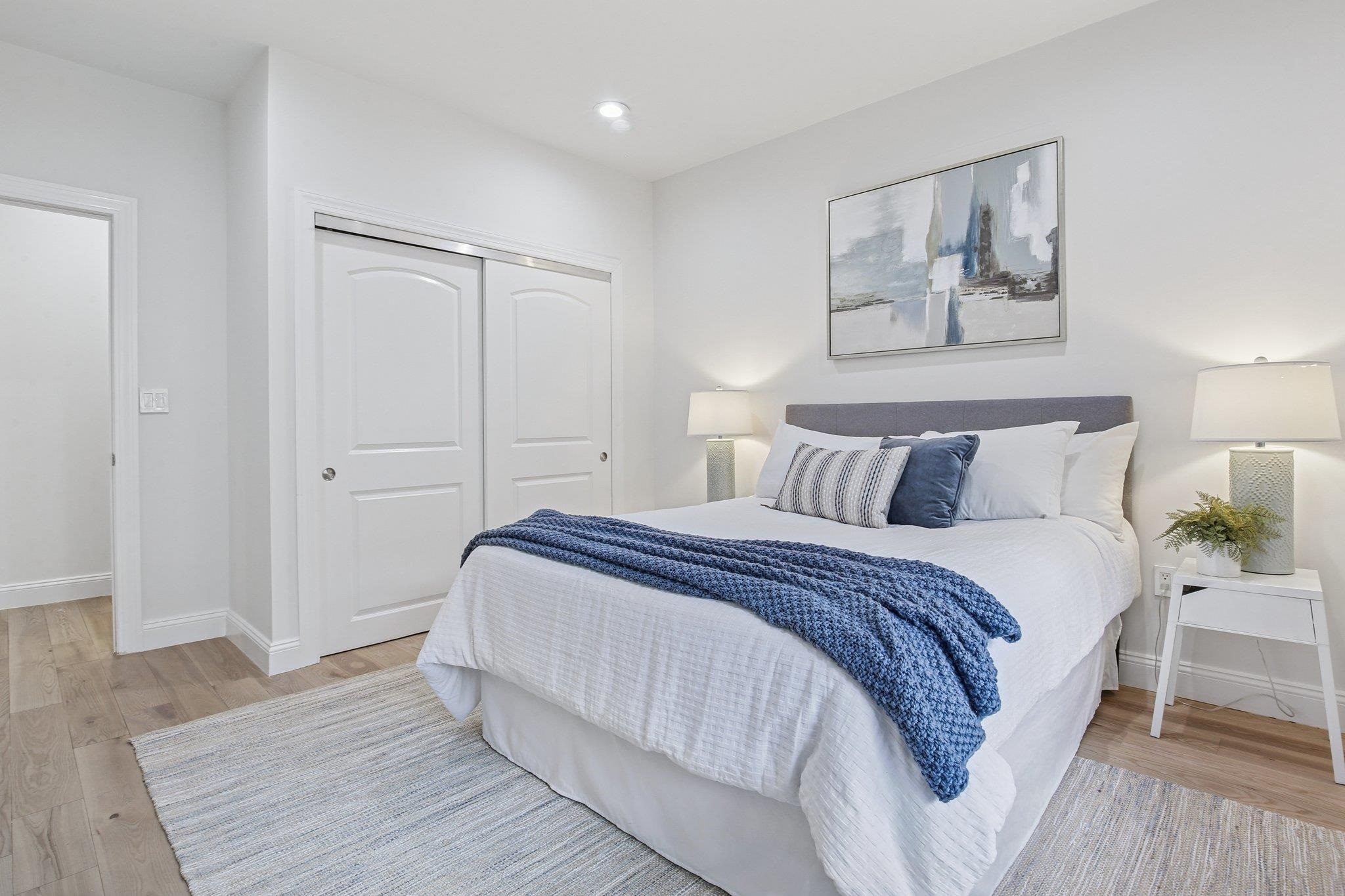 22 Ave At Port Imperial, Unit 208 West New York, NJ 07093 - Photo 8 of 34 a bedroom with bed and night stand