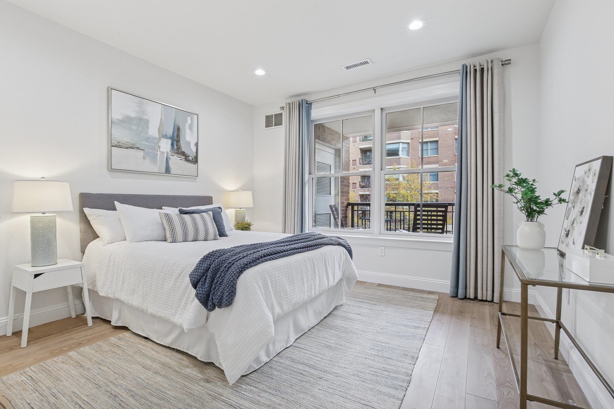 22 Ave At Port Imperial, Unit 208 West New York, NJ 07093 - Photo 9 of 34 a spacious bedroom with a large bed and a potted plant