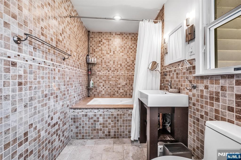 408 Chelsea Street Paramus, NJ 07652 - Photo 26 of 49 a bathroom with a shower and a sink