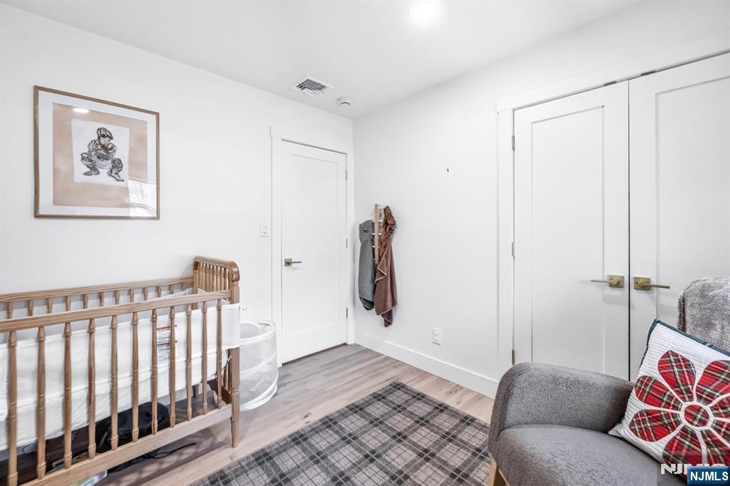 408 Chelsea Street Paramus, NJ 07652 - Photo 30 of 49 a bedroom with furniture and wooden floor