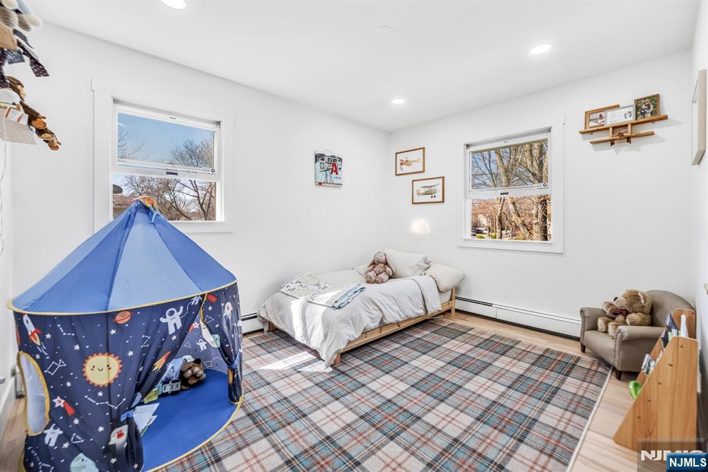 408 Chelsea Street Paramus, NJ 07652 - Photo 31 of 49 a bedroom with furniture and wooden floor