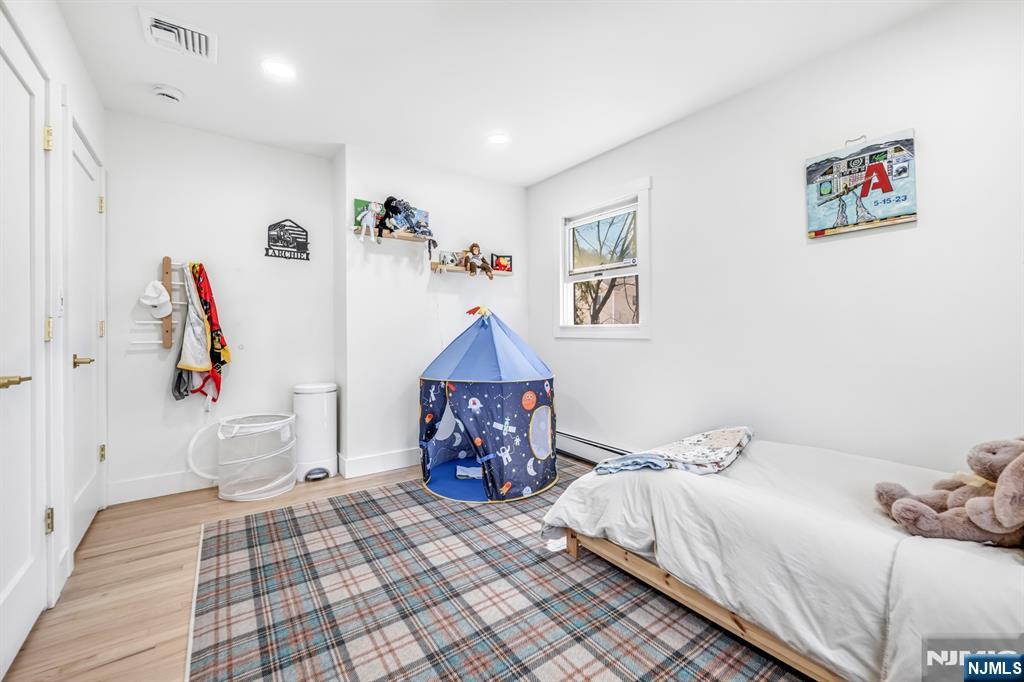 408 Chelsea Street Paramus, NJ 07652 - Photo 32 of 49 a bedroom with a bed and a couch