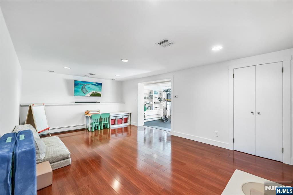 408 Chelsea Street Paramus, NJ 07652 - Photo 33 of 49 a living room with furniture and a wooden floor