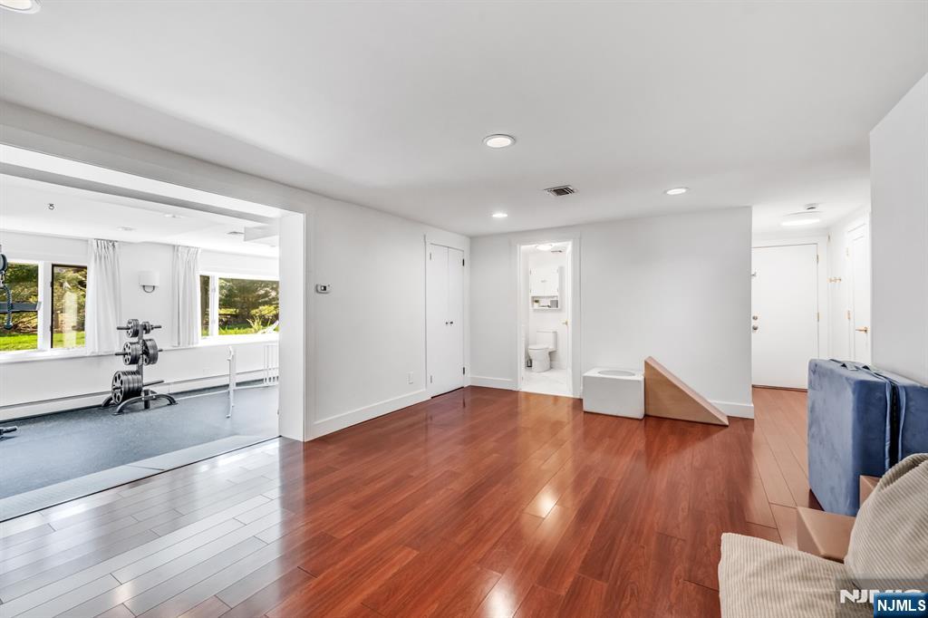 408 Chelsea Street Paramus, NJ 07652 - Photo 34 of 49 a view of empty room with wooden floor and windows