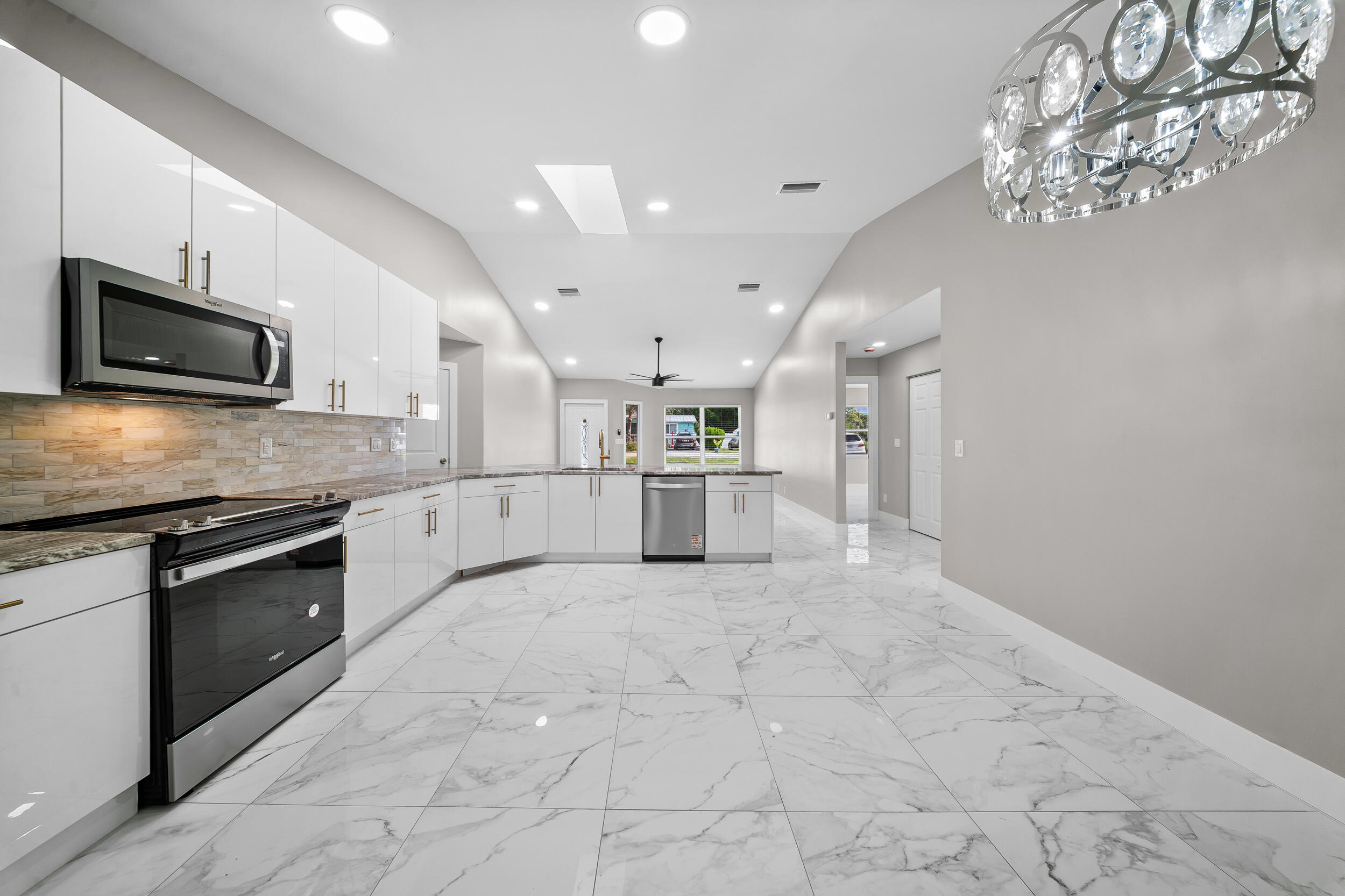 1627 Southeast Monroe Street Stuart, FL 34997 - Photo 13 of 33 a large kitchen with cabinets and stainless steel appliances