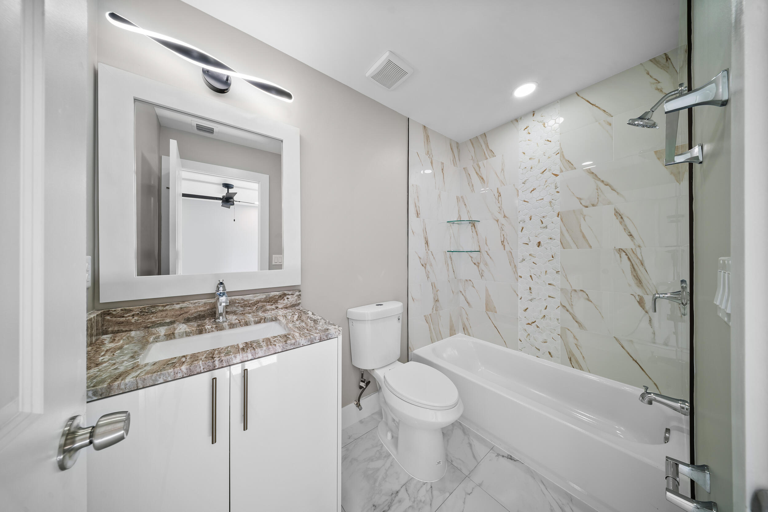 1627 Southeast Monroe Street Stuart, FL 34997 - Photo 19 of 33 a bathroom with a granite countertop sink toilet and shower