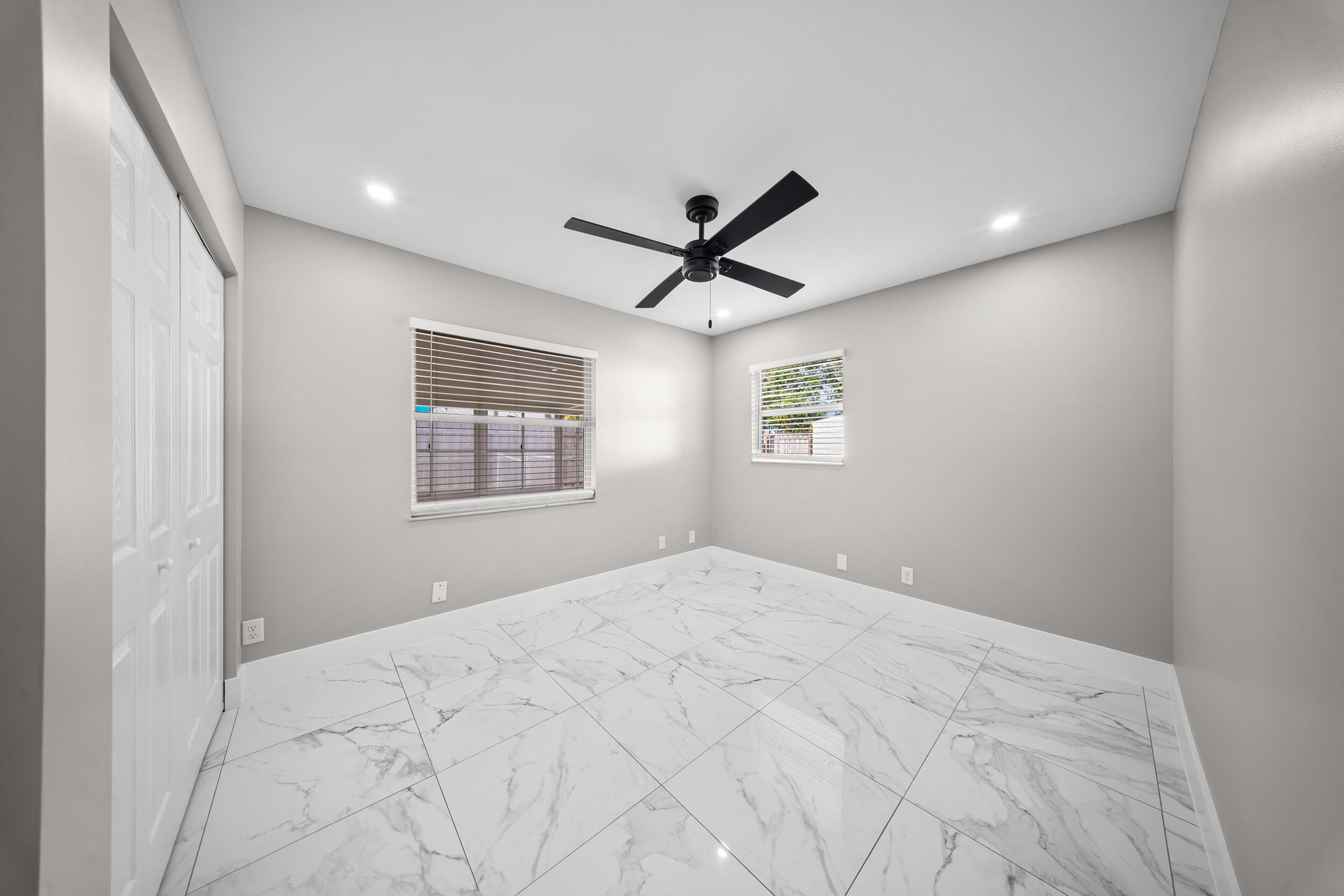 1627 Southeast Monroe Street Stuart, FL 34997 - Photo 20 of 33 a view of a livingroom with a ceiling fan & windows