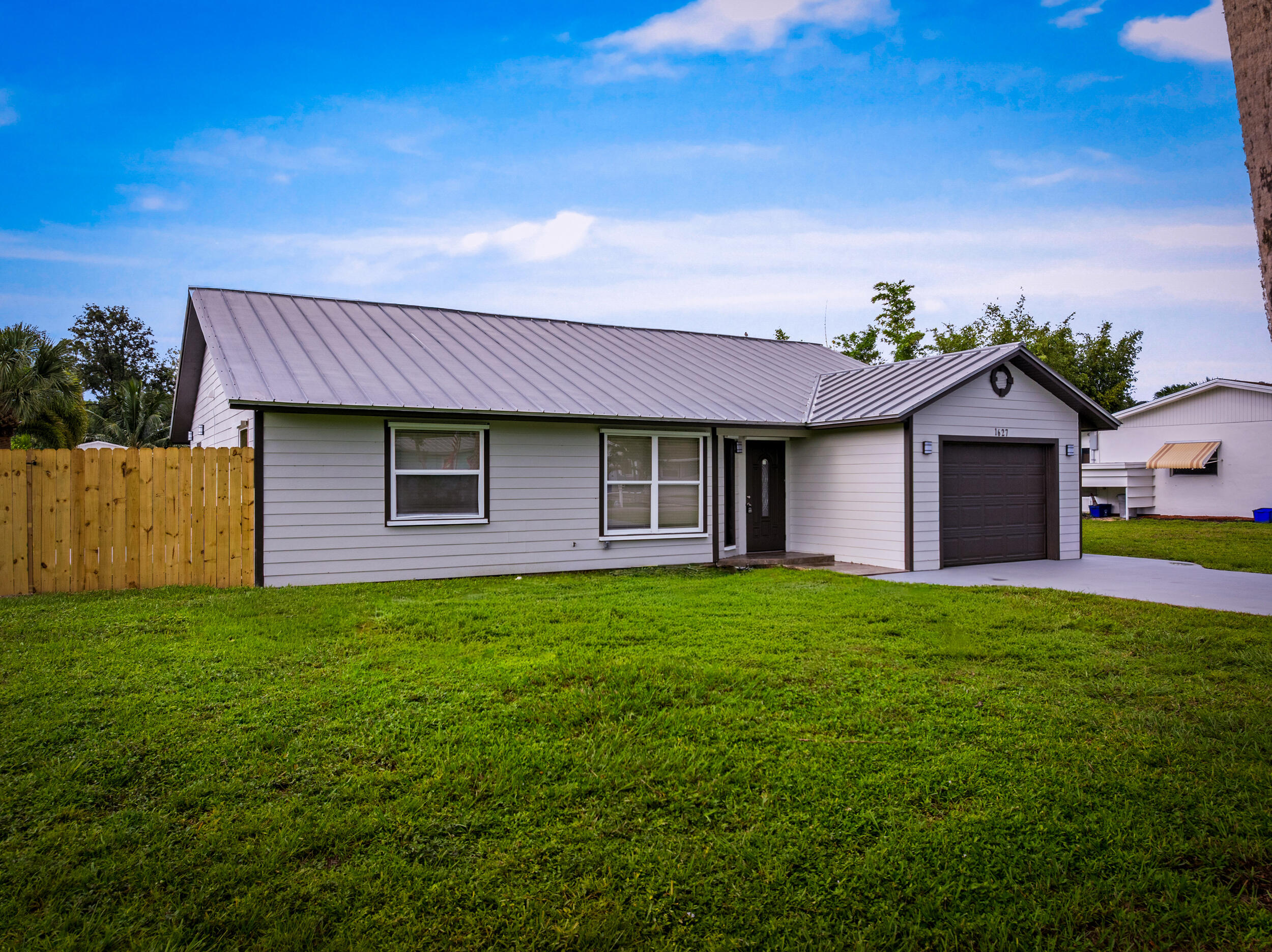 1627 Southeast Monroe Street Stuart, FL 34997 - Photo 2 of 33 a front view of a house with garden