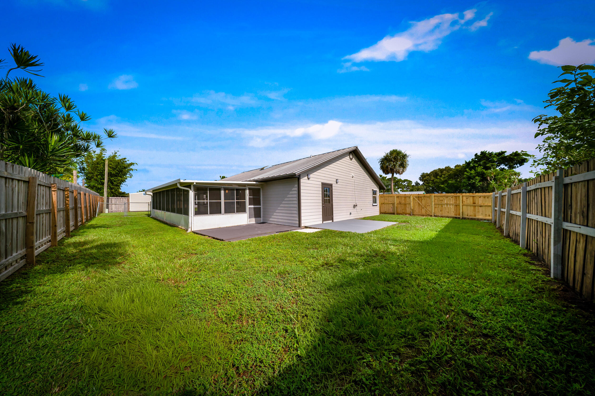 1627 Southeast Monroe Street Stuart, FL 34997 - Photo 27 of 33 a view of a backyard with plants and large trees