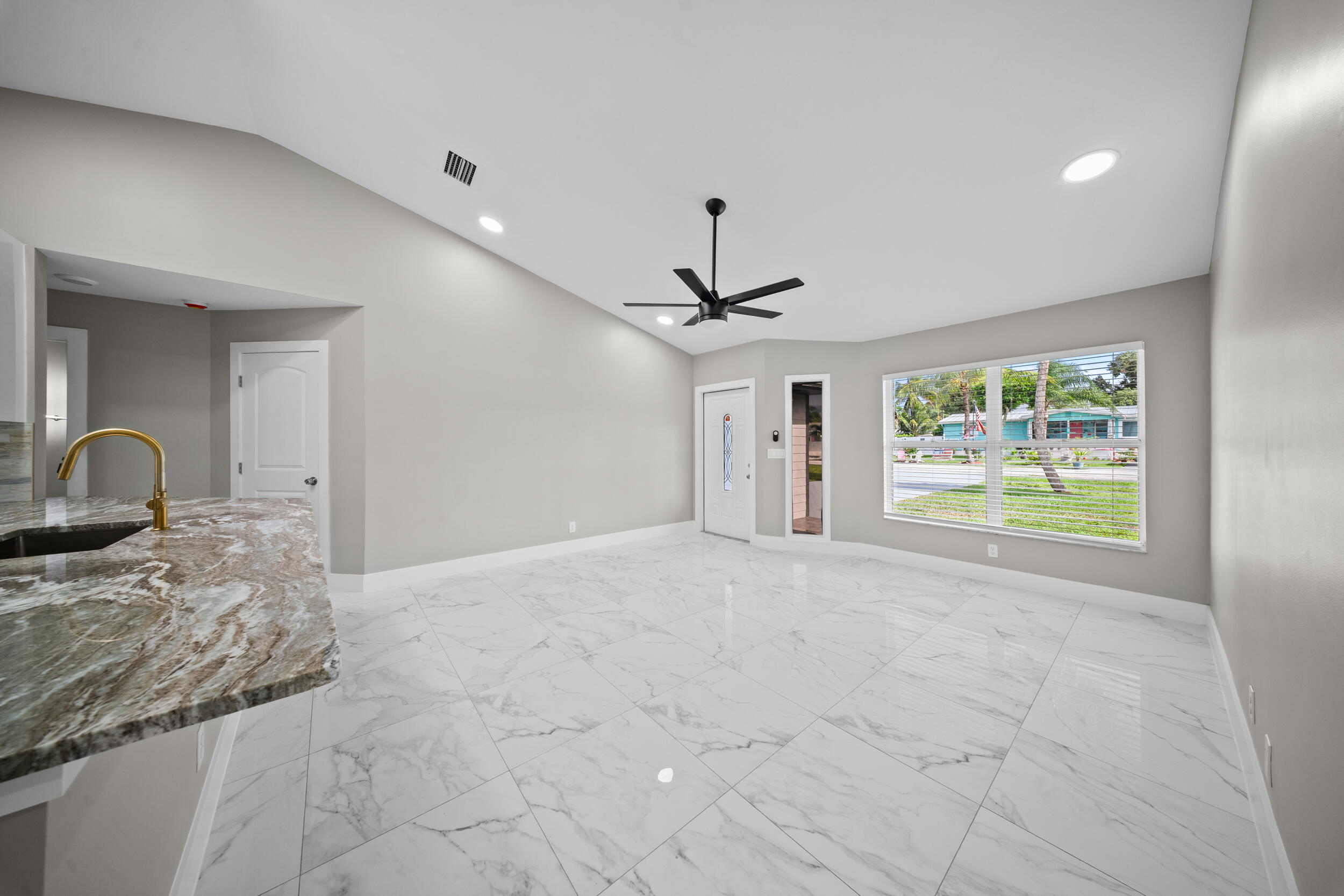 1627 Southeast Monroe Street Stuart, FL 34997 - Photo 9 of 33 a very nice looking room with a large window