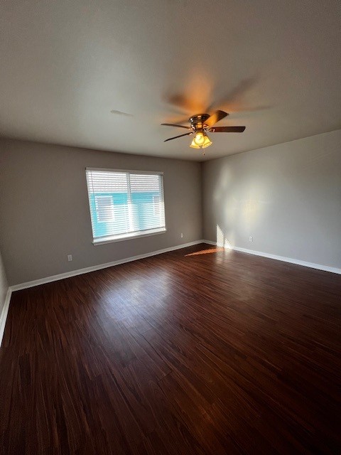 1172 Webberville Road Austin, TX 78721 - Photo 3 of 9 Unfurnished room featuring dark wood finished floors and ceiling fan