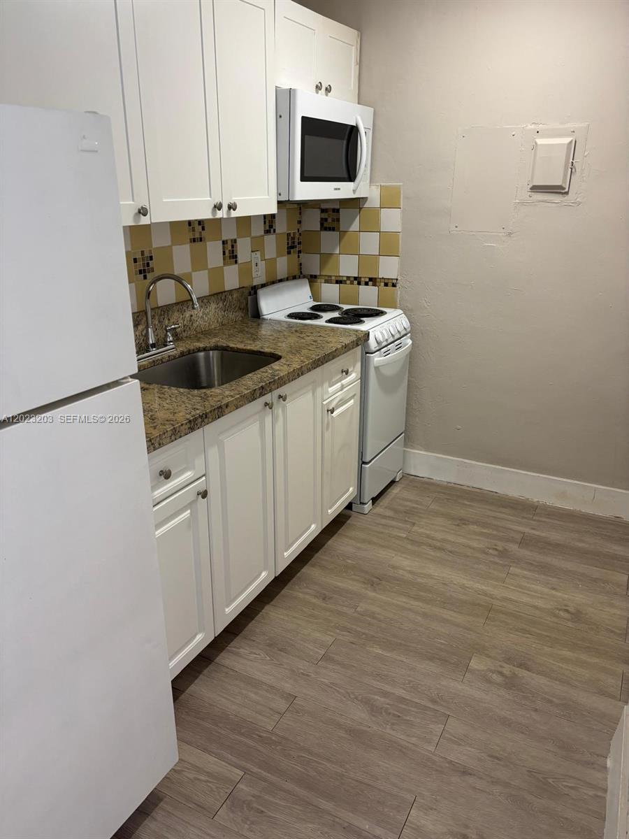 520 Southwest 4th Street, Unit 11 Miami, FL 33130 - Photo 7 of 7 a kitchen with stainless steel appliances a sink stove and microwave