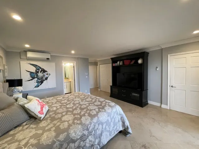 a bedroom with a bed and a television in it