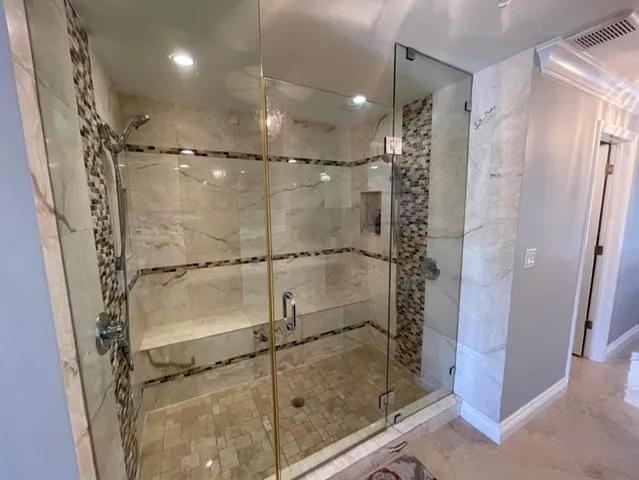a bathroom with a glass shower door