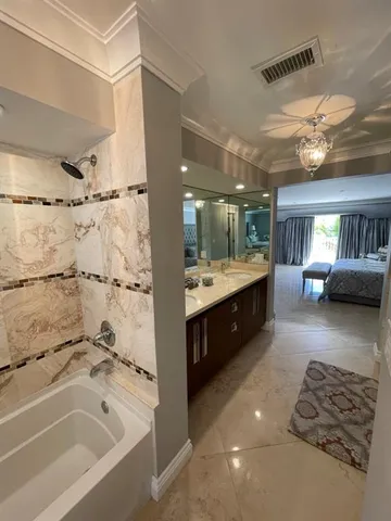 a bedroom with a bed and large window