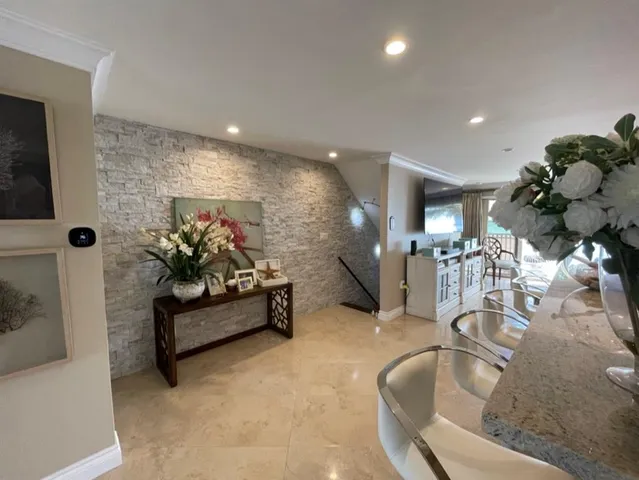 a living room with furniture flowerpot and a chandelier