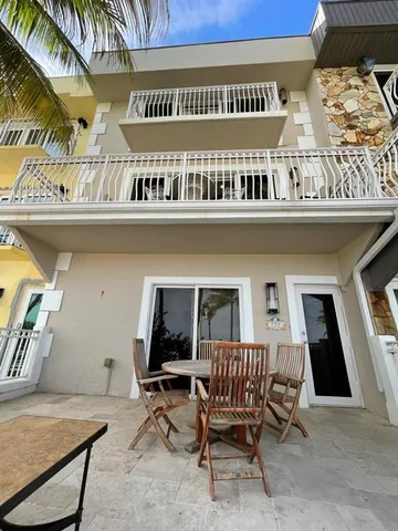 a view of a chairs and table in a balcony