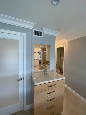 a bathroom with a glass door shower a sink and vanity