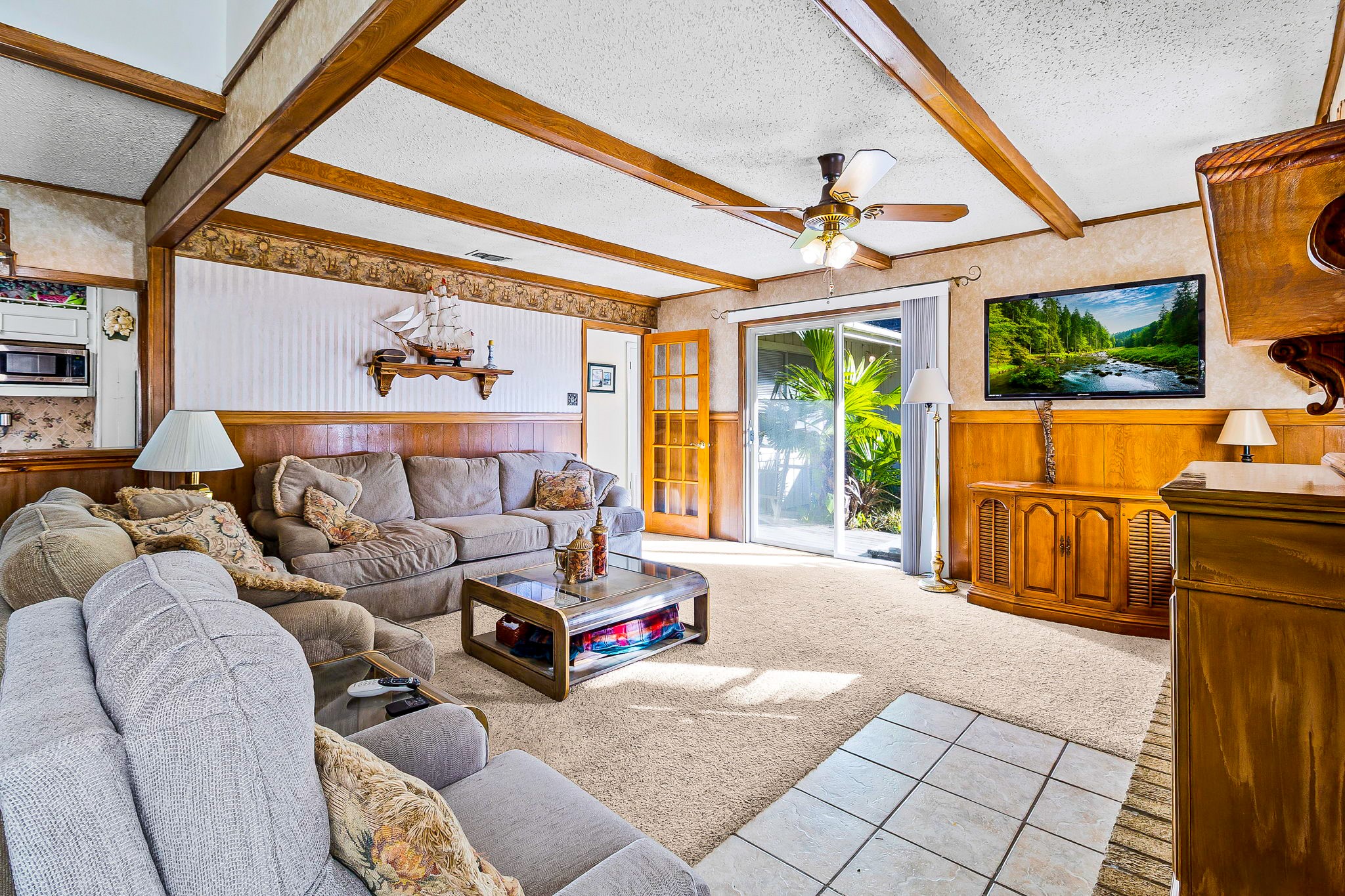 a living room with furniture and a floor to ceiling window