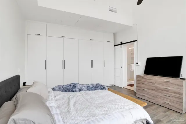 a bedroom with a bed and a flat screen tv