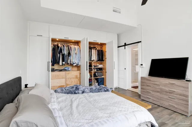 a bedroom with a bed and a flat screen tv