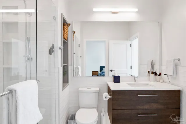 a bathroom with a sink toilet and shower