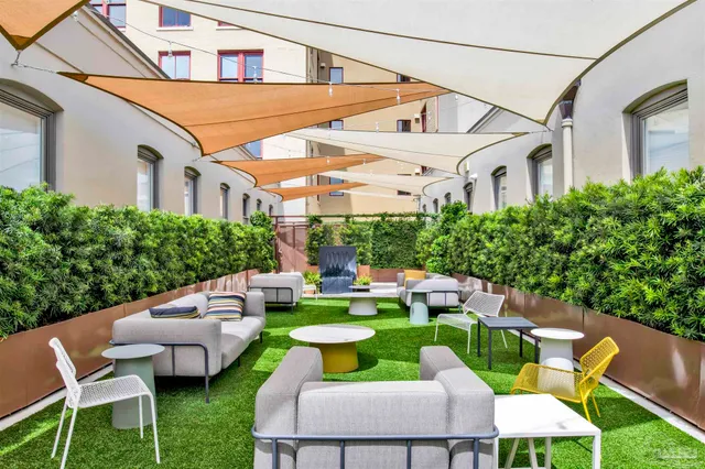a view of a patio with couches chairs and a fire pit