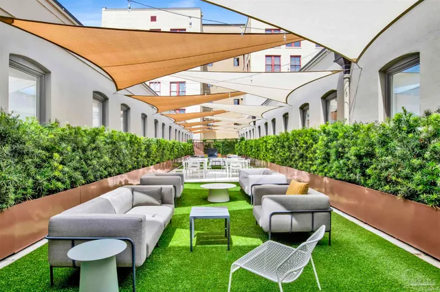 a view of a patio with couches chairs and a yard
