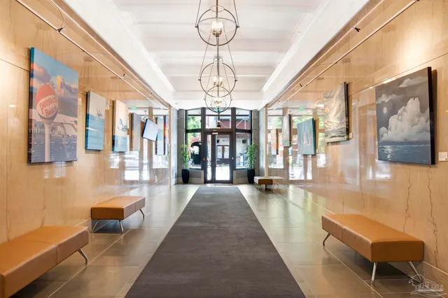 a lobby with furniture and a chandelier