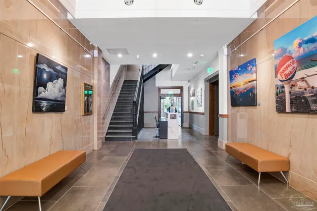 a view of a hallway with stairs and a furniture