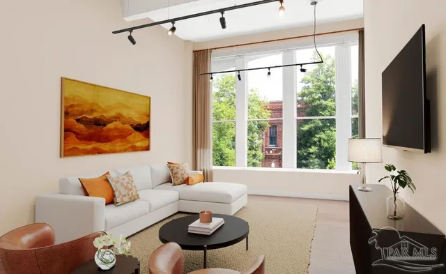 a living room with furniture a flat screen tv and a large window