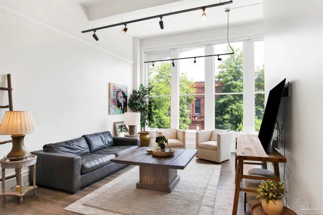 a living room with furniture and a large window