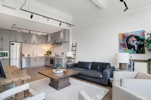 a living room with furniture and kitchen view