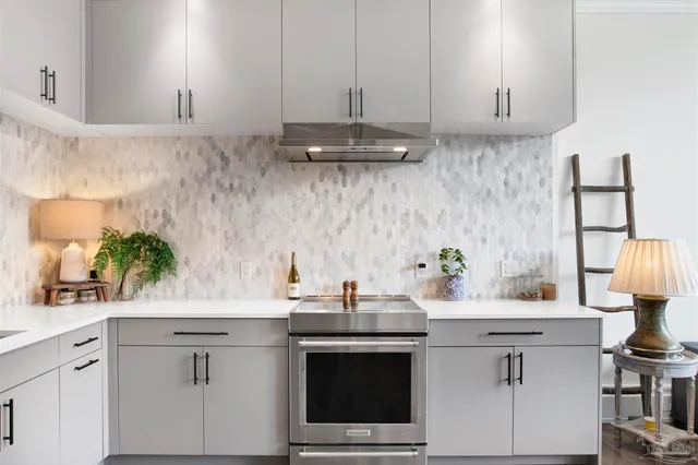 a kitchen with stainless steel appliances a sink stove and cabinets