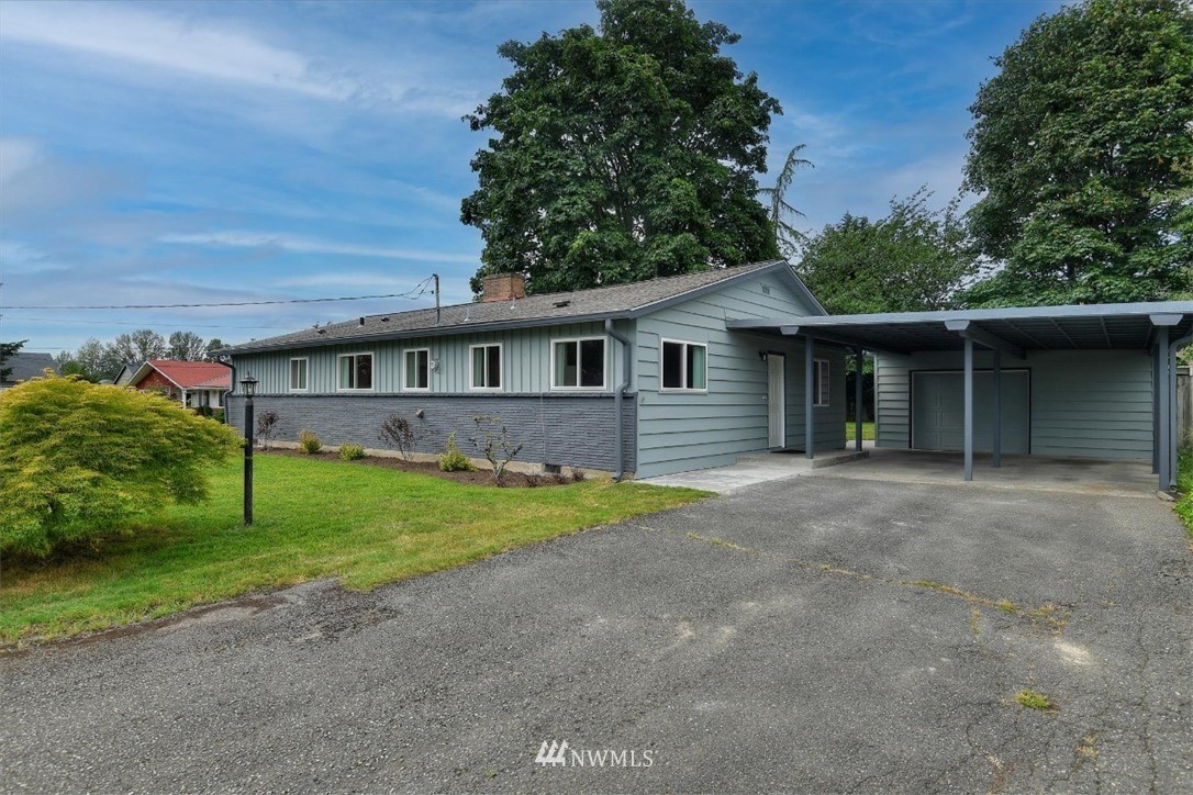 5202 Northeast 3rd Street Renton, WA 98059 - Photo 1 of 27 a front view of a house with a garden and yard