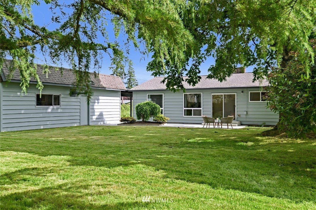 5202 Northeast 3rd Street Renton, WA 98059 - Photo 2 of 27 a front view of a house with a garden