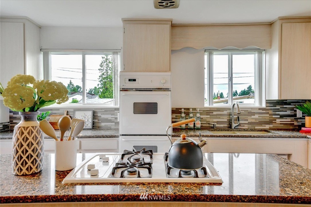 5202 Northeast 3rd Street Renton, WA 98059 - Photo 11 of 27 a kitchen with a stove a sink and a cabinets