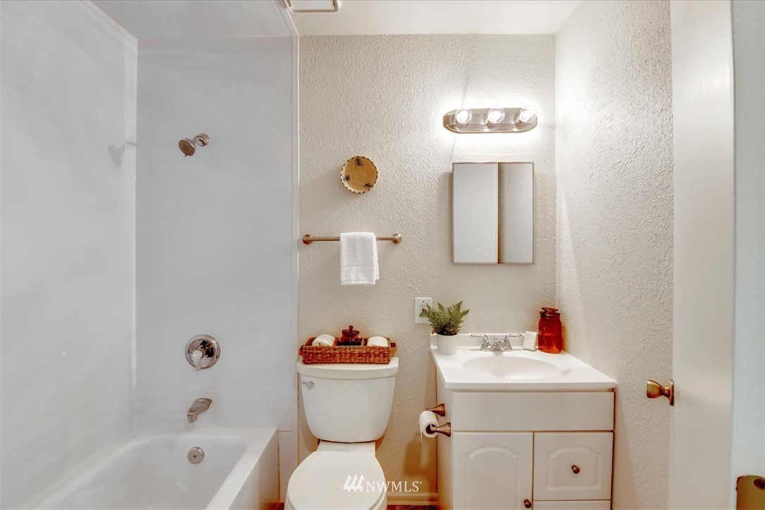 5202 Northeast 3rd Street Renton, WA 98059 - Photo 16 of 27 a bathroom with a sink mirror vanity and toilet