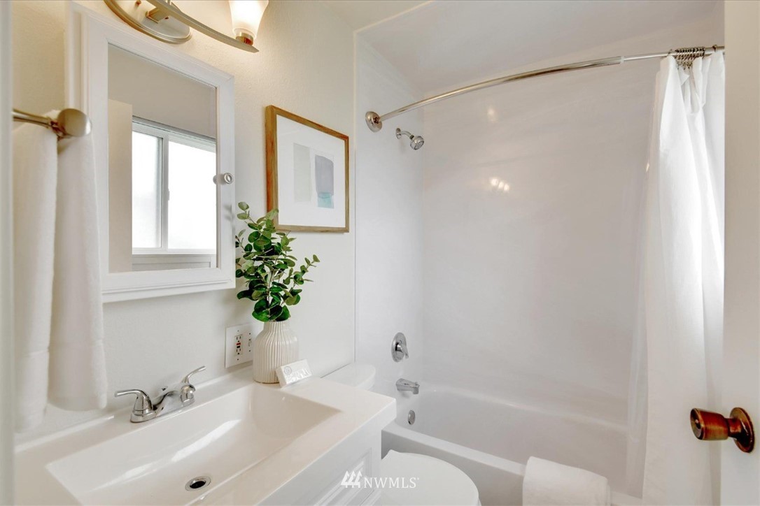 5202 Northeast 3rd Street Renton, WA 98059 - Photo 17 of 27 a bathroom with a bathtub shower sink vanity and a toilet