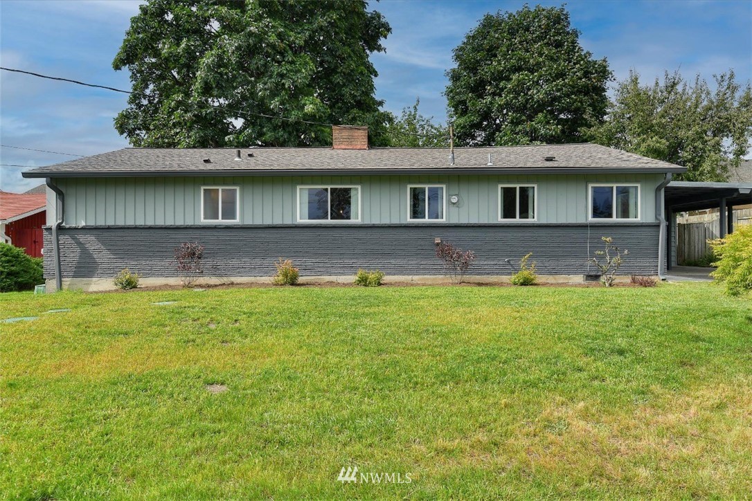 5202 Northeast 3rd Street Renton, WA 98059 - Photo 27 of 27 a front view of house with yard and trees in the background