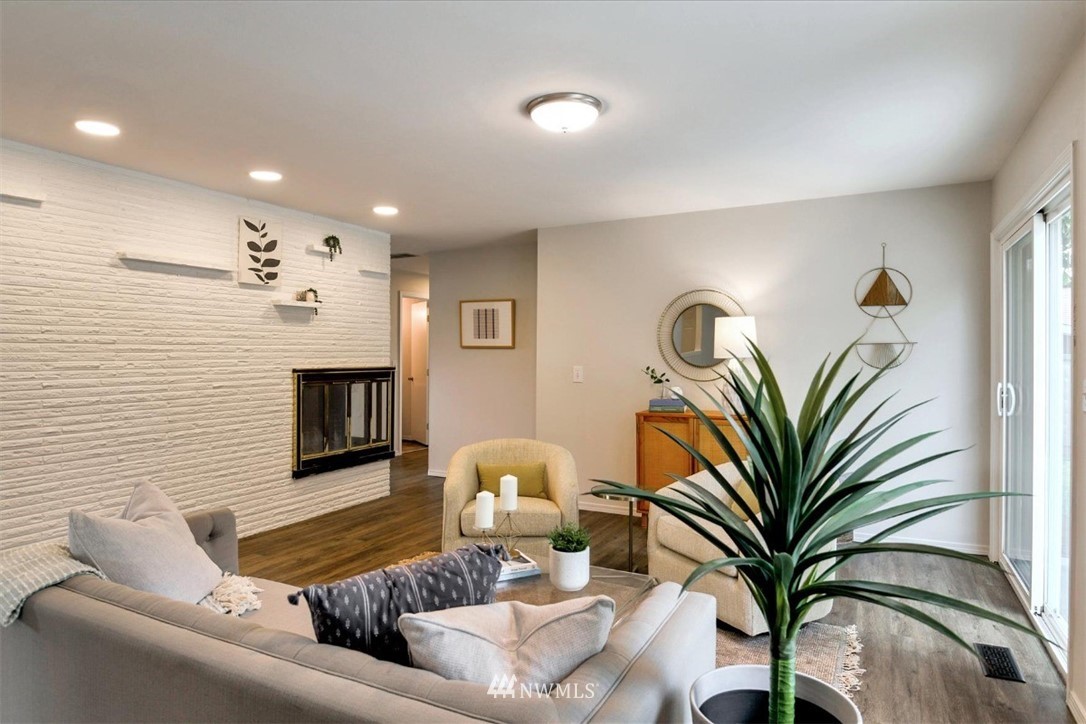 5202 Northeast 3rd Street Renton, WA 98059 - Photo 7 of 27 a living room with furniture flowerpot and a fireplace