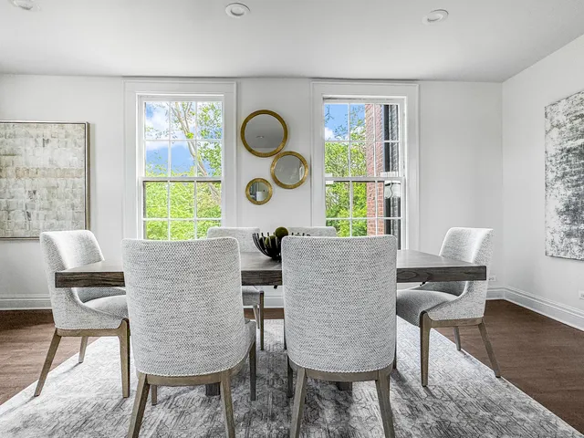 a kitchen with a table chairs refrigerator and couch