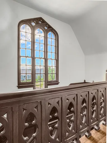 a bedroom with a bed a couch and dresser with wooden floor